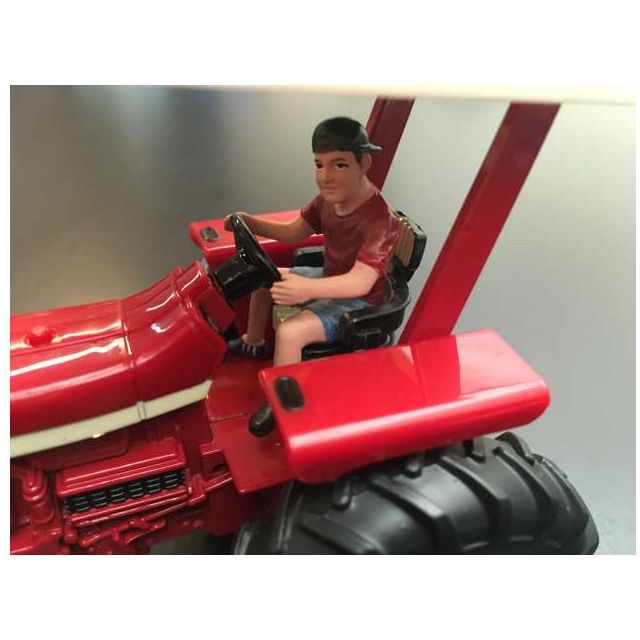 Young farmer driving tractor - 1:32
